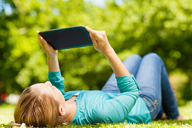istock Relaxed Woman Looking At Digital Tablet 174765062