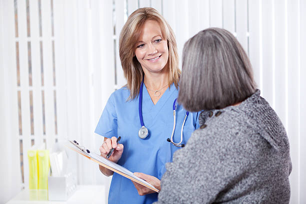 istock Nurse Helping Senior Patient with Paper Work and Forms Hz 174765077