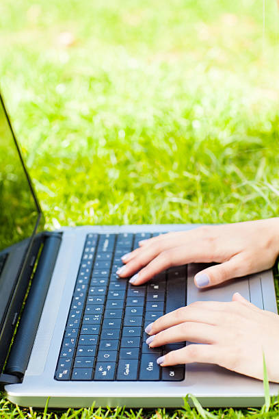 istock Woman's Hands Typing On Laptop At Park 174765649
