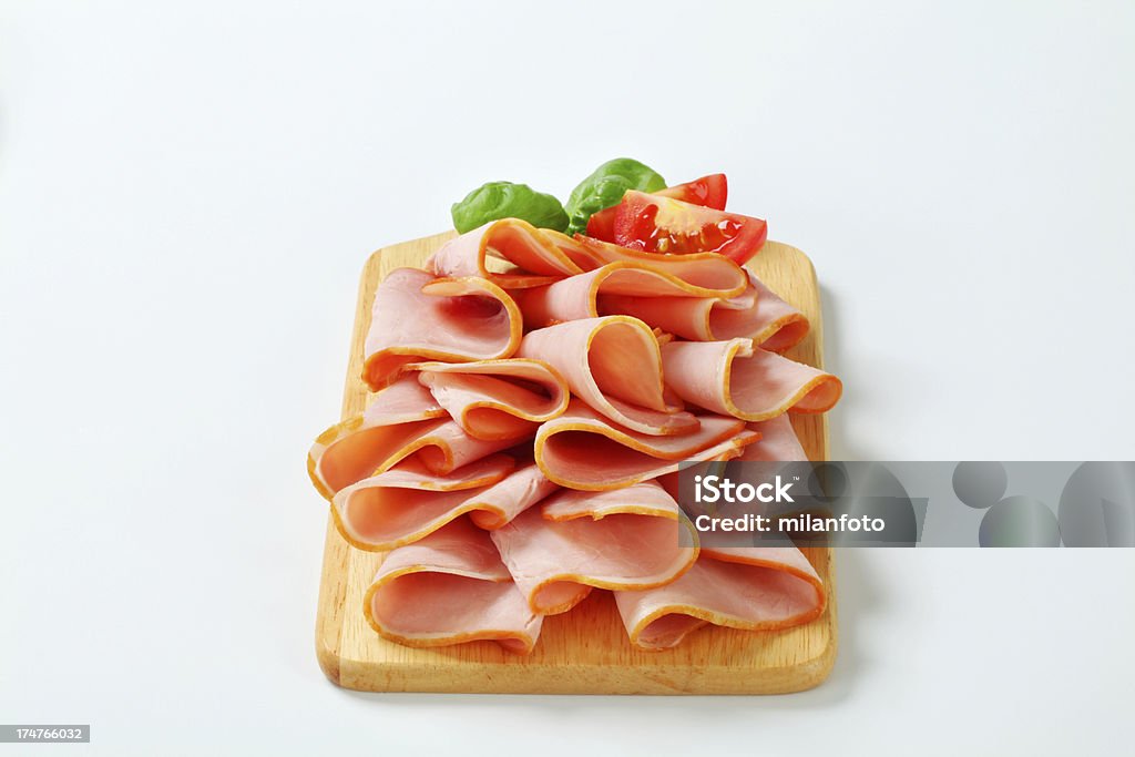 Fette di prosciutto affumicato su un tagliere - Foto stock royalty-free di Alimentazione sana