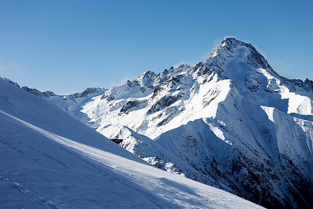 Landscape with snow tops in valley of Gonachkhir River in Teberdinsky National Park. Dombay, Karachay-Cherkessia, Russia