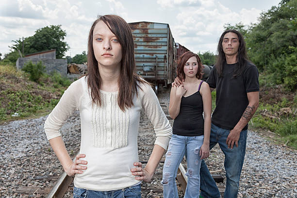 Skater chick with her boys behind her. 