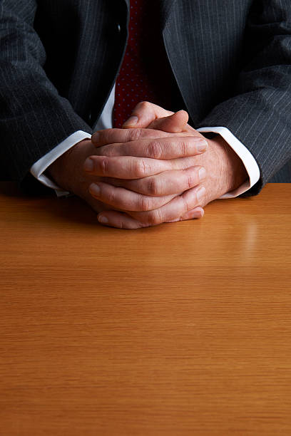 istock Businessman Sitting At Desk With Folded Hands 174766989