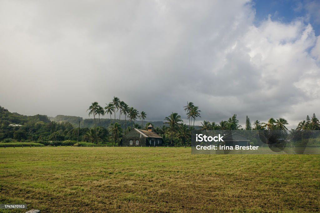 A view of the old church at Keanae Point on Maui, Hawaii. Black lava rocks line the shore at Keanae on the road to Hana in Maui, Hawaii Ancient Stock Photo