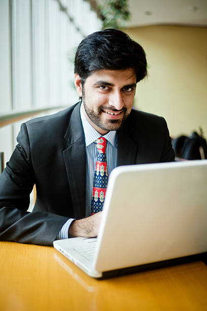 istock Young Asian Indian Businessman working on laptop in cafeteria 174767183