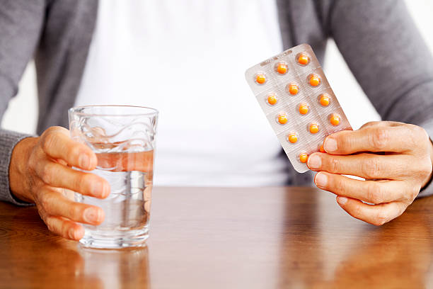 istock mature woman taking medication 174767413