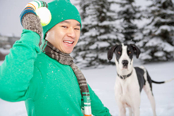 Smiling male playing with dog