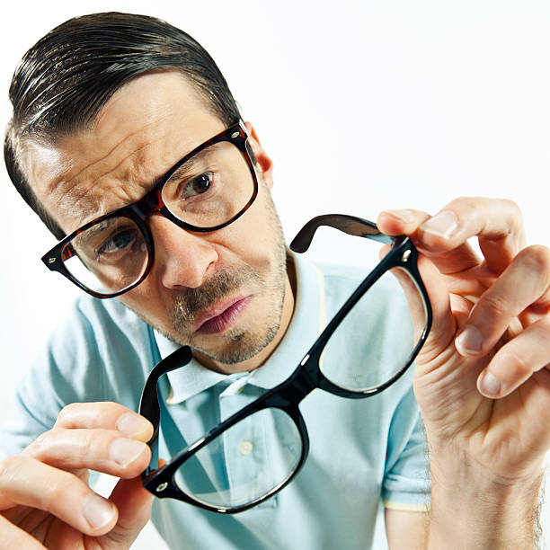istock Man wears glasses another pair is holding in hands 174767978
