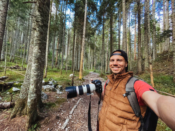 istock Photographer taking selfie in the woods 1747681868