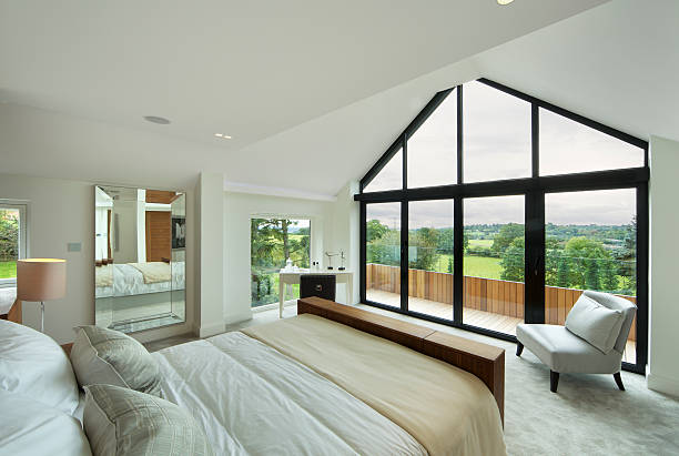 fabulous penthouse bedroom a fabulous bedroom in a luxury new home with a lovely aspect through the large balcony windows towards rolling countryside. A large mirror is to the left whilst a dressing table / desk is to the centre. On the right is a silk covered chair. Looking for a Bedroom image Then please see my other Bedrooms and related images by clicking on the Lightbox link below... patio cover stock pictures, royalty-free photos & images