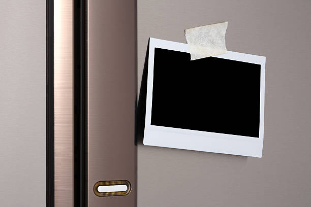 Blank photo on Refrigerator Door polaroid  fastened to the front of a stainless steel refrigerator refrigerator photos stock pictures, royalty-free photos & images