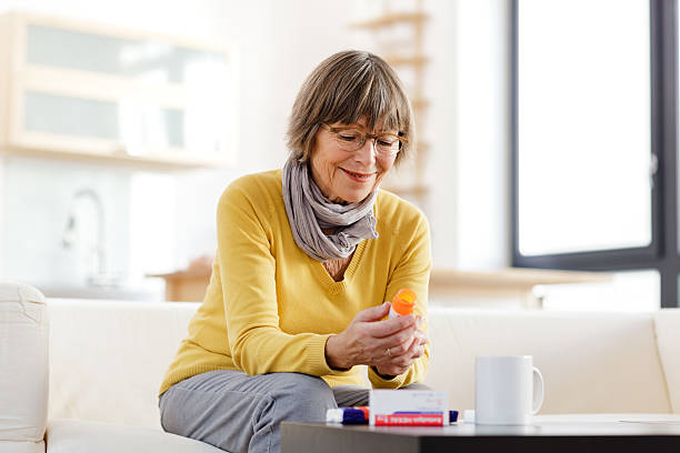 istock Senior woman reading label on medicine 174770181