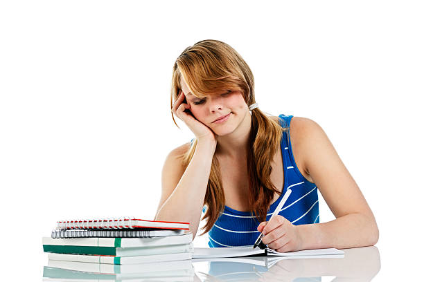 Frustrated and bored teenager studies resentfully