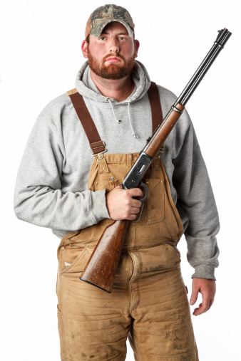 A portrait of a hunter with a shotgun. Isolated on white.