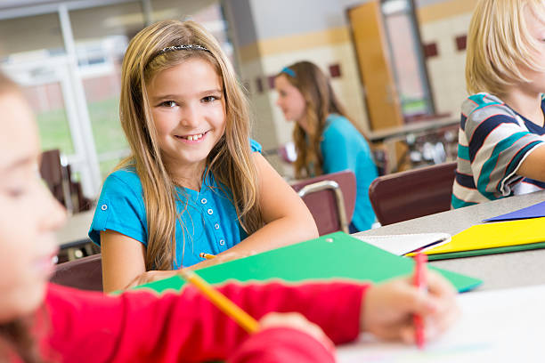 istock Happy cute student at school with other students 174770720