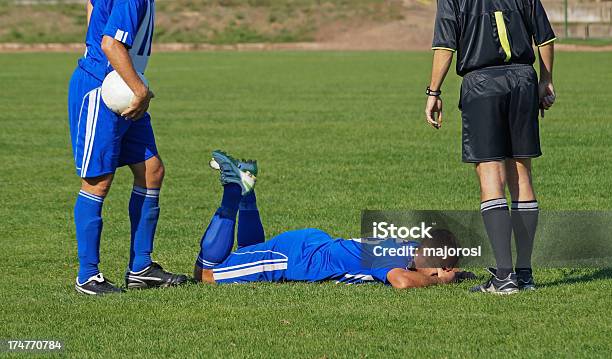 Two Soccer Players And A Referee Stock Photo - Download Image Now - Lying Down, Soccer Player, Adult