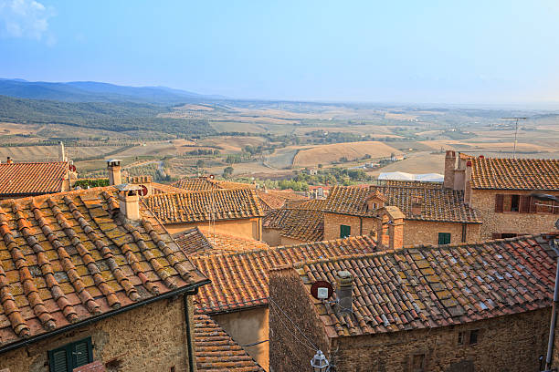 View over the roofs of the old city of Casale Marittimo into the plain below around the city of Bibbona. Tuscany, Italy.