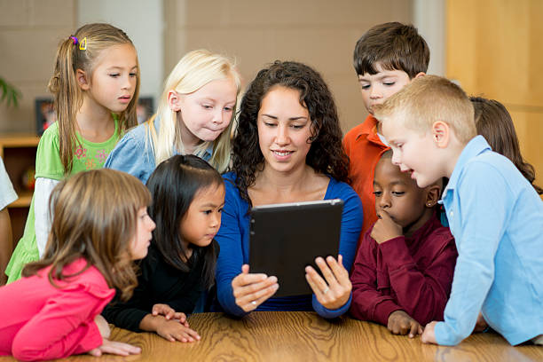 istock Teacher with pre-schoolers and tablet 174771041