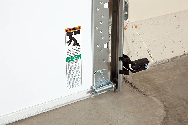 Garage Door Crush Warning Sticker and Reversing Sensor stock photo