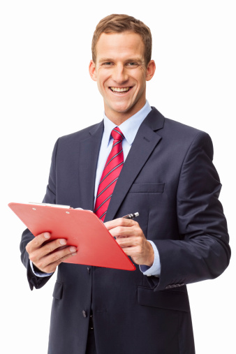 Portrait of a happy young business executive writing on clipboard. Vertical shot. Isolated on white.