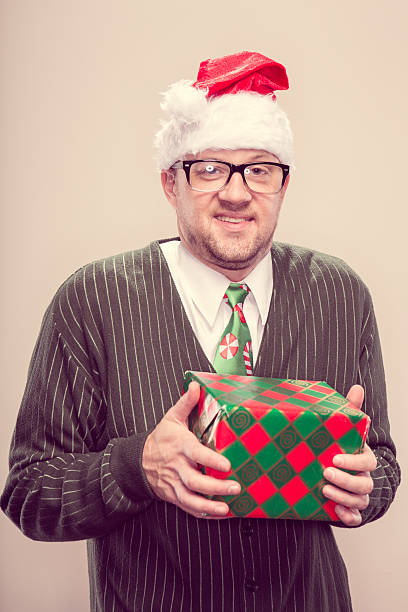 istock Vintage Nerdy Christmas Man holding wrapped gift 174771597