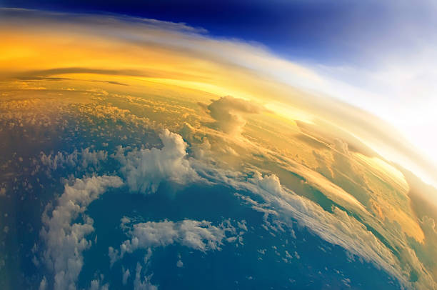 The First Sunlight of Planet Earth "Aerial view of Planet Earth with clouds, horizon and little bit of space, make feelings of being in heaven. Dramatic clouds and orange sunlight all over the planet. Cloudscape and stratosphere from above at 30000 feet.See more images like this in:" satellite view photos stock pictures, royalty-free photos & images