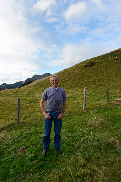 istock Swiss Farmer Stands in His Pasture 174772018