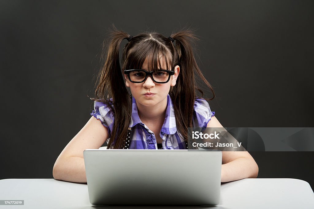 Angry Nerd Girl An angry looking nerdy girl on the computer Anger Stock Photo
