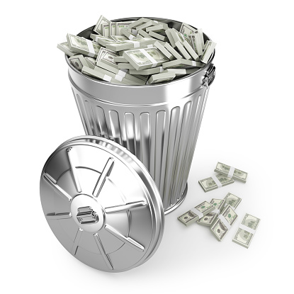 Digitally generated image of rubbish bin filled with money. Isolated on white