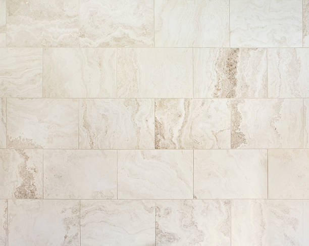 natural travertine stone tiles a section of large rectangular natural stone travertine tiles on a wall of a bathroom. This type of light coloured stone is popular with bathroom design for large new homes.Looking for more images of tiles or more images of bathrooms Then please click on the Lightbox links below... marble bathroom wall stock pictures, royalty-free photos & images