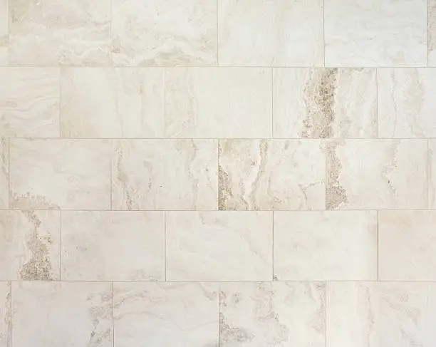 a section of large rectangular natural stone travertine tiles on a wall of a bathroom. This type of light coloured stone is popular with bathroom design for large new homes.Looking for more images of tiles or more images of bathrooms Then please click on the Lightbox links below...