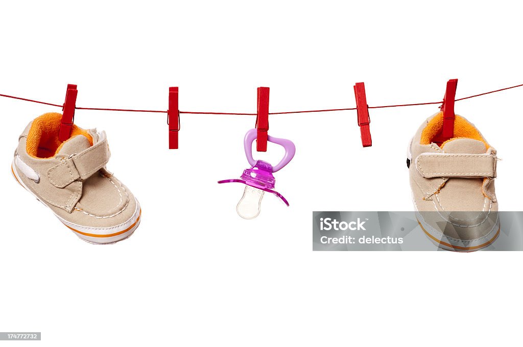 Concept baby - pregnancy Concept baby - pregnancy. Baby shoes and pacifier on a clothesline. Baby Booties Stock Photo