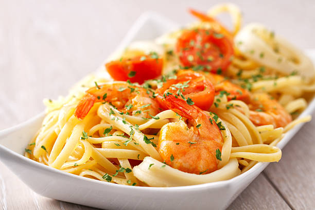 Spaghetti is a long, thin, solid, cylindrical pasta. It is a staple food of traditional Italian cuisine. Like other pasta, spaghetti is made of milled wheat and water and sometimes enriched with vitamins and minerals. Italian spaghetti is typically made from durum wheat semolina.\nSquid is eaten in many cuisines, in English, the culinary name calamari is often used for squid dishes. There are many ways to prepare and cook squid. Fried squid is common in the Mediterranean. In Lebanon and Syria, \nit is served with tartar sauce.\nMussel is the common name used for members of several families of bivalve molluscs, from saltwater and freshwater habitats. These groups have in common a shell whose outline is elongated and asymmetrical compared with other edible clams, which are often more or less rounded or oval.\nShrimp and prawn are types of seafood that are consumed worldwide. Although shrimp and prawns belong to different suborders of Decapoda, they are very similar in appearance and the terms are often used interchangeably in commercial farming and wild fisheries. A distinction is drawn in recent aquaculture literature, which increasingly uses the term \
