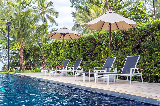 Poolside seats,Relaxing chairs beside swimming pool