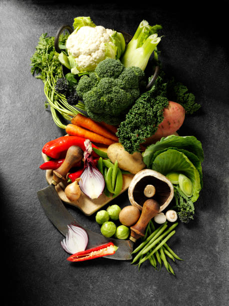 istock Green and Root Vegetables on a Antique Chopping Board 174773986