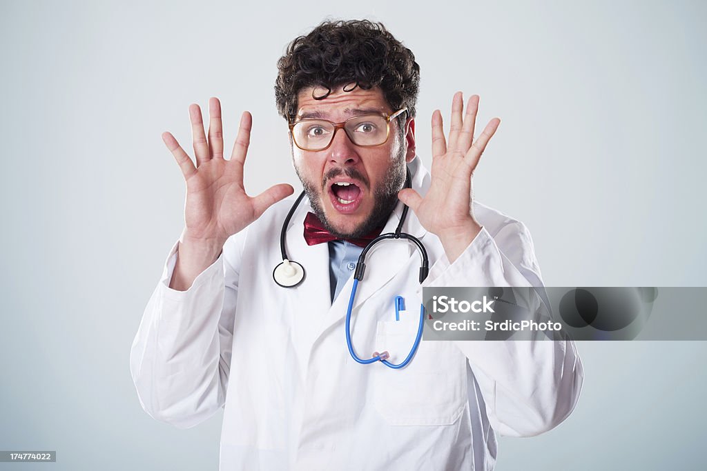 Fear Scared nerdy male doctor with glasses gesturing with hands up Doctor Stock Photo