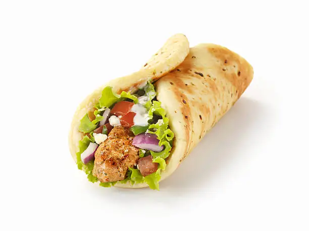 "Pork Souvlaki Pita Wrap with Lettuce, Tomatoes, Red Onions, Feta Cheese and Tzatziki Sauce  -Photographed on Hasselblad H3D-39mb Camera"