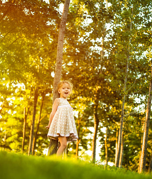 istock Little girl resting on tree in the park 174774762