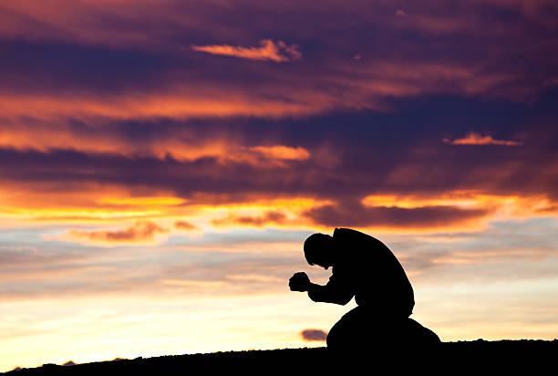 istock Silhouette of Man Praying 174774912