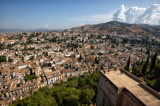 A photo of the mountain peak of Alhambra in Granada with the snow filled peaks of Sierra Nevada in the background