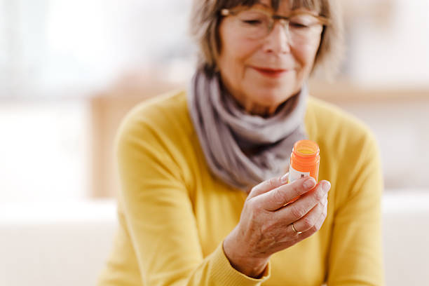 istock Senior woman reading label on medicine 174776298