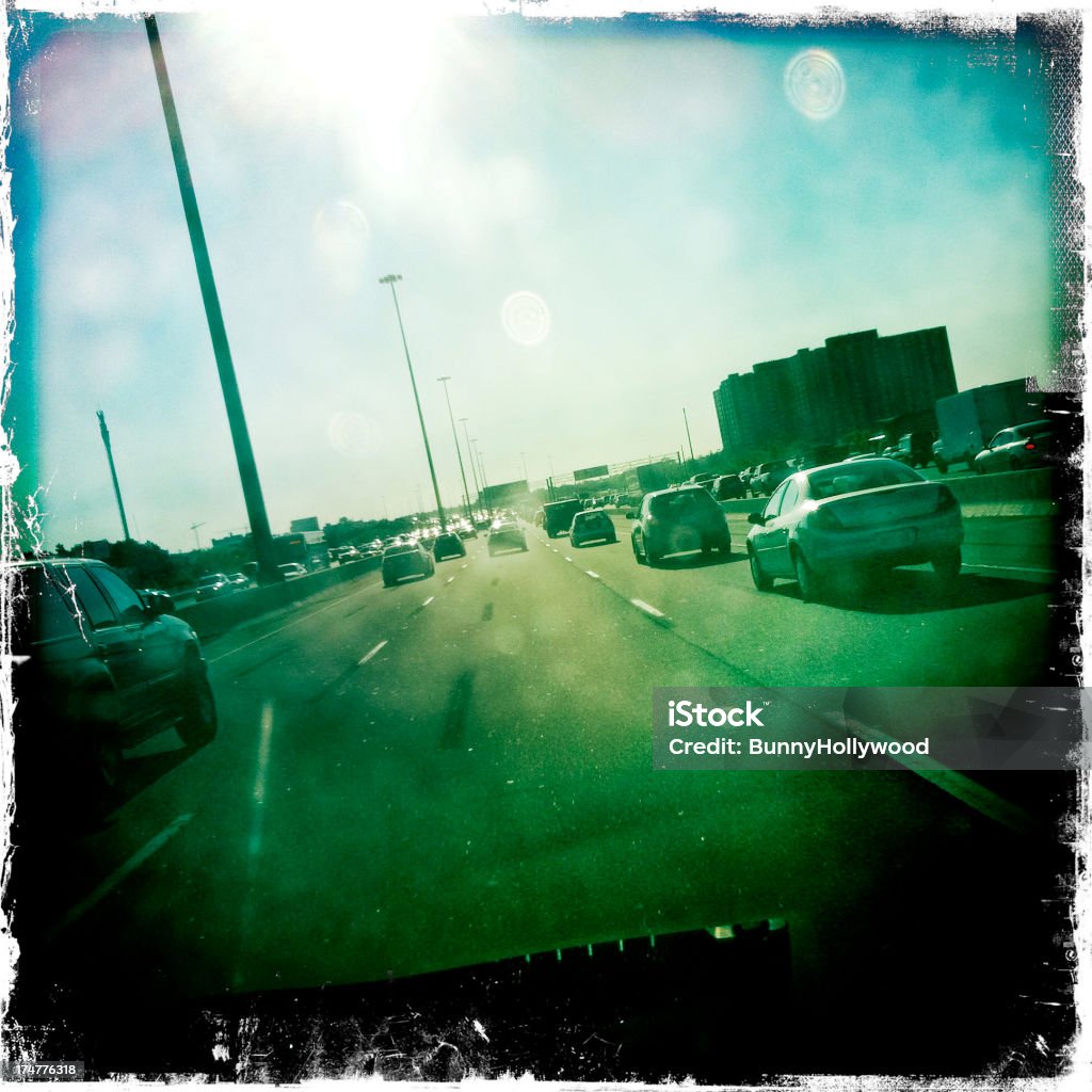 city freeway traffic an open lane in rush hour traffic in a mid-size North American city, viewed through a textured and sun spotted windshield Brightly Lit Stock Photo