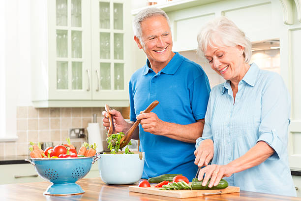 istock Senior couple at countertop making a salad 174776828