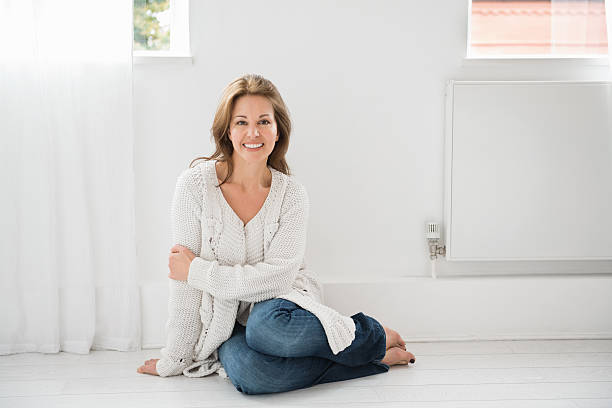 istock Smiling Mature Woman Sitting On Floor 174777151