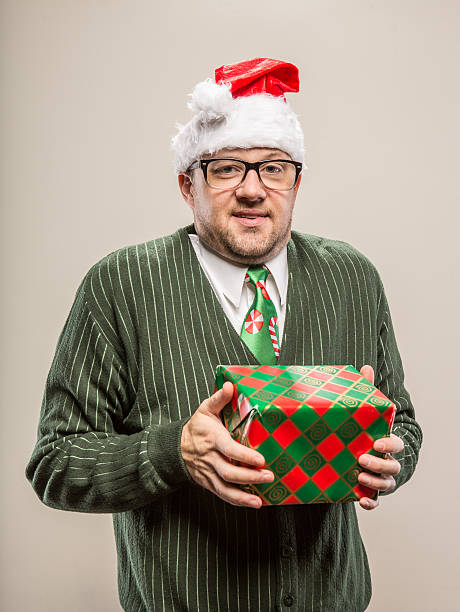istock Goofy Nerdy Christmas Man holding wrapped gift 174777613