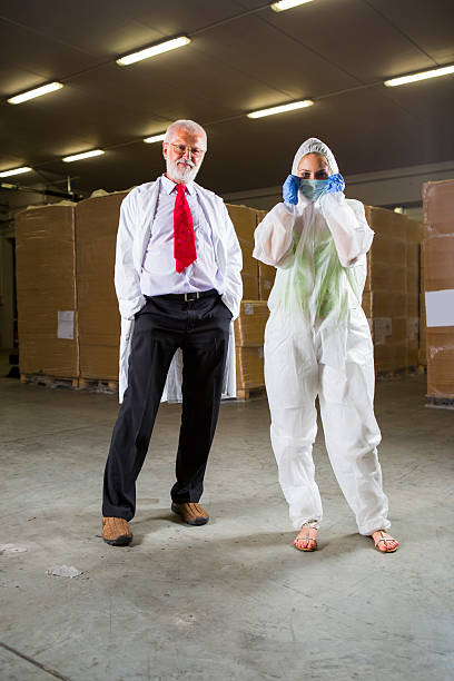 istock Warehouse worker and beautiful supervisor in a hazmat suit 174777711