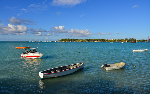 Grand Baie, Mauritius - Jan 9, 2017. Boats on beautiful sea at sunny day in Grand Baie, Mauritius Island. Mauritius is a major tourist destination, ranking 3rd in the region.
