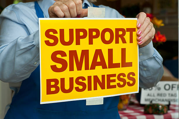 istock Support small business sign being put on store door 174778267
