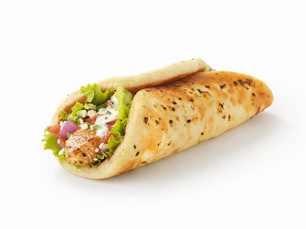 Chicken Souvlaki Wrap "Chicken Souvlaki Pita Wrap with Lettuce, Tomatoes, Red Onions, Feta Cheese and Tzatziki Sauce  -Photographed on Hasselblad H3D-39mb Camera" pita bread isolated stock pictures, royalty-free photos & images