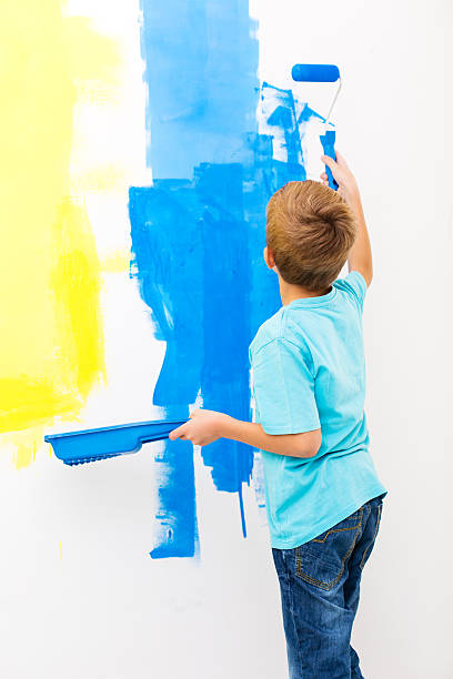 istock Little boy painting the wall 174778726